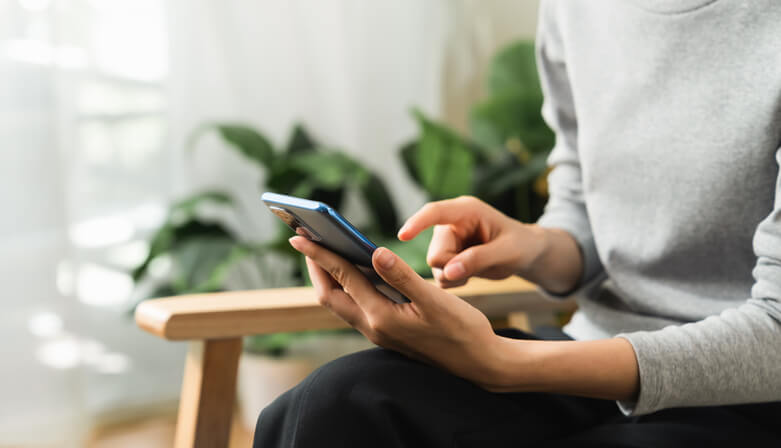 a woman at her mental health clinic looking through her phone 