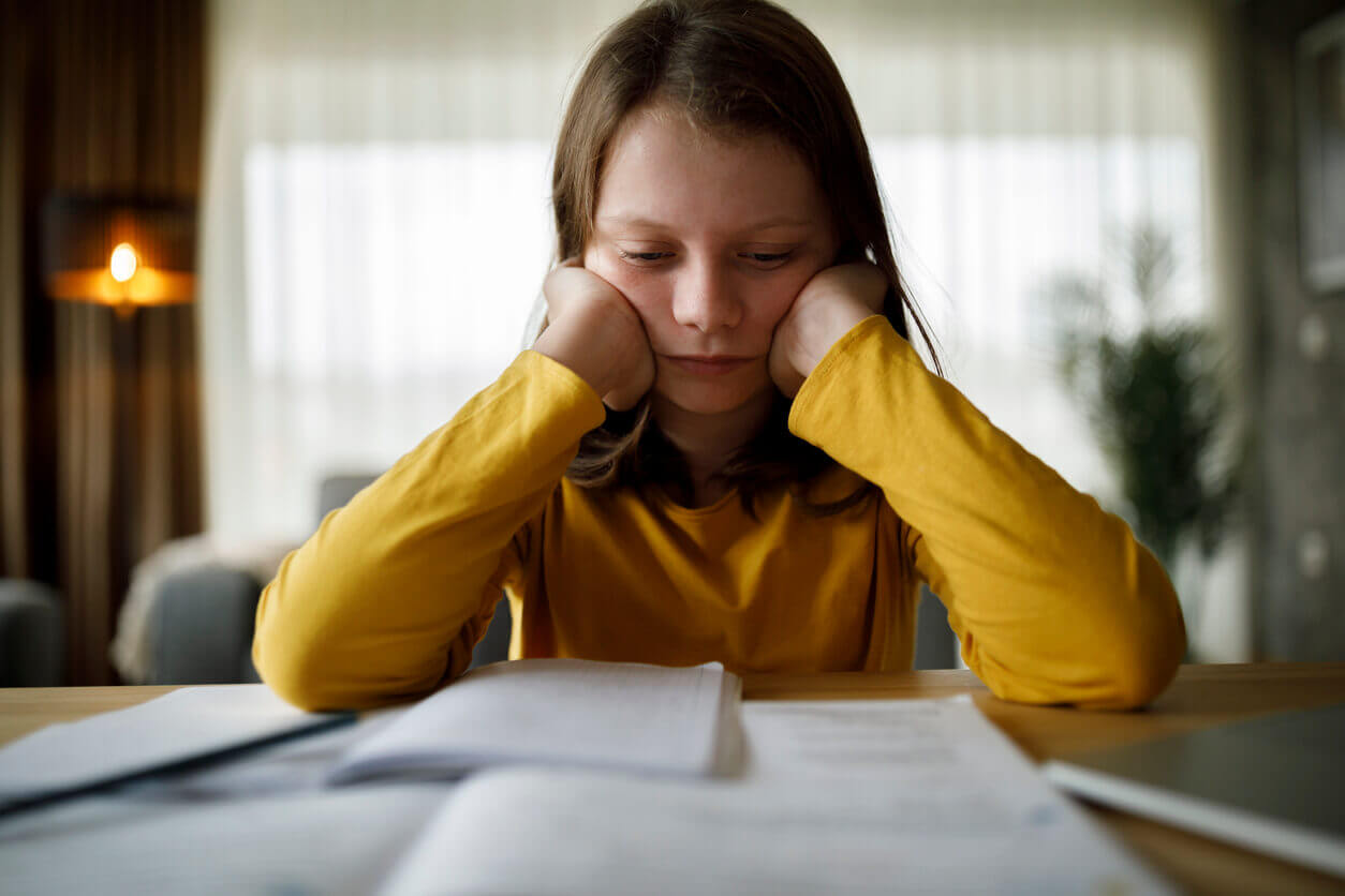 Little girl with ADHD, trying to concentrate and read a book