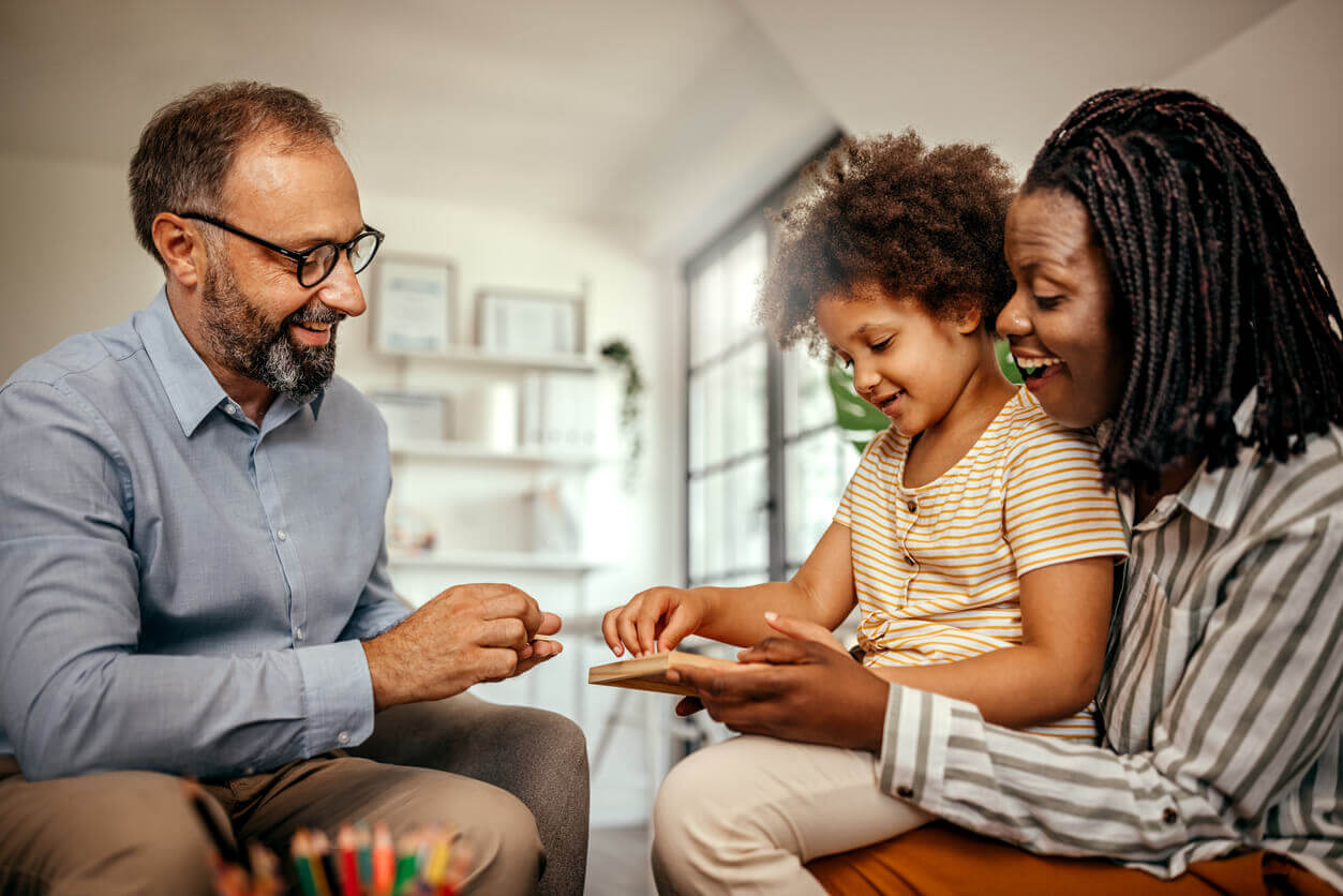 parents of an autistic child playing a board game 