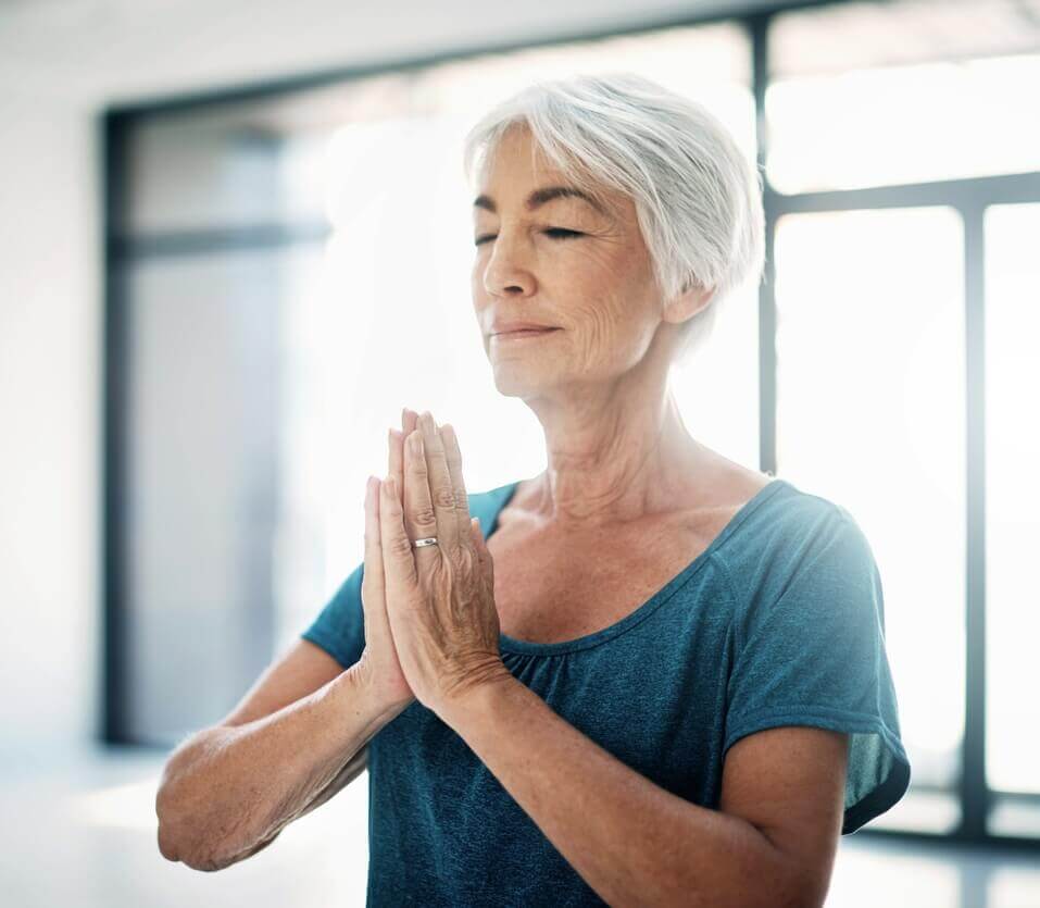 older woman doing a yoga pose